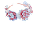 Floral headband with pink and white flowers on a light background