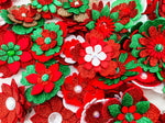 A mixture of red, white, green and gold flower hair clips with rhinestone centres