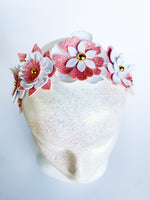 Heart-shaped cake with floral decorations on a white background