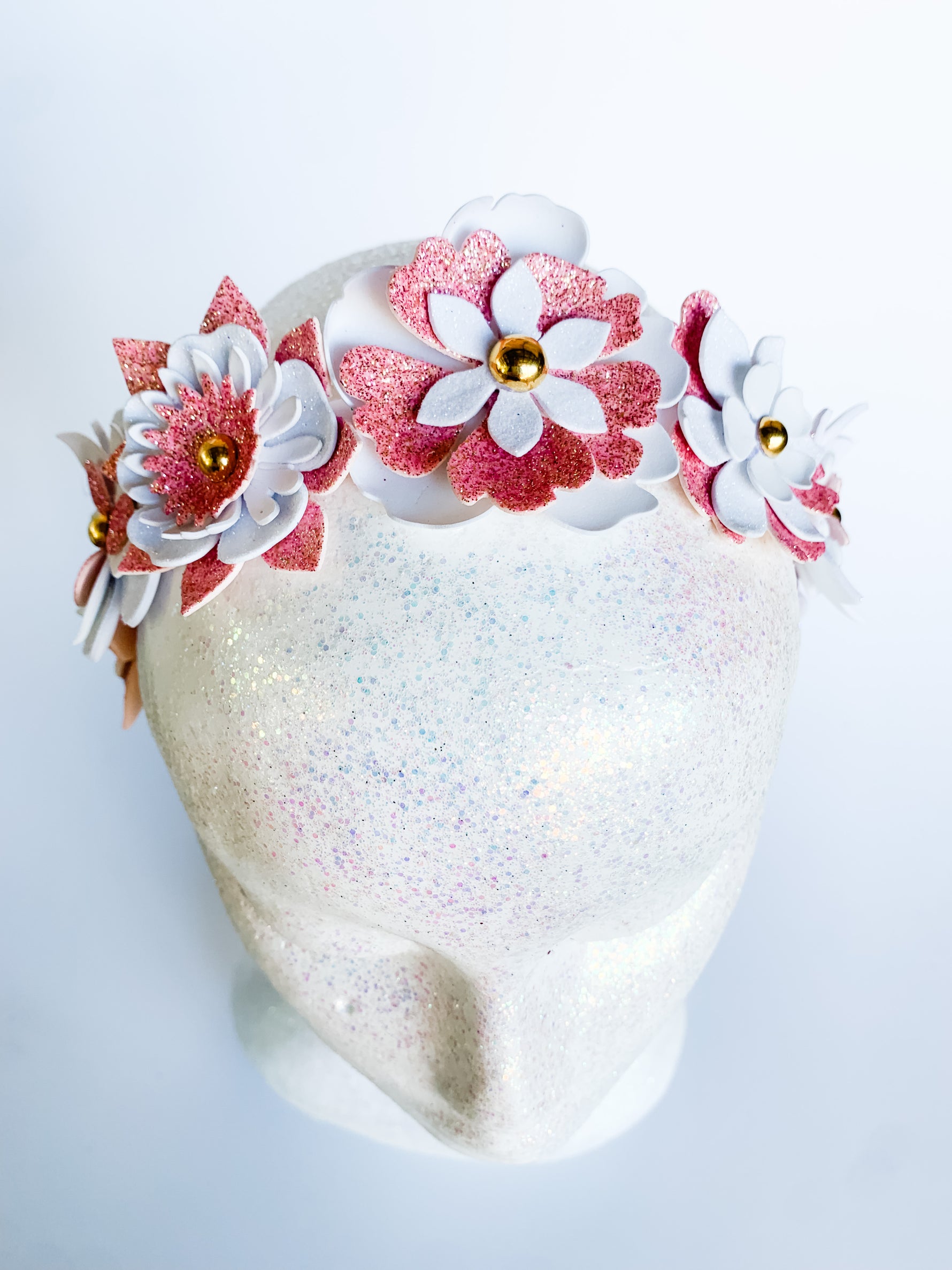 Heart-shaped cake with floral decorations on a white background