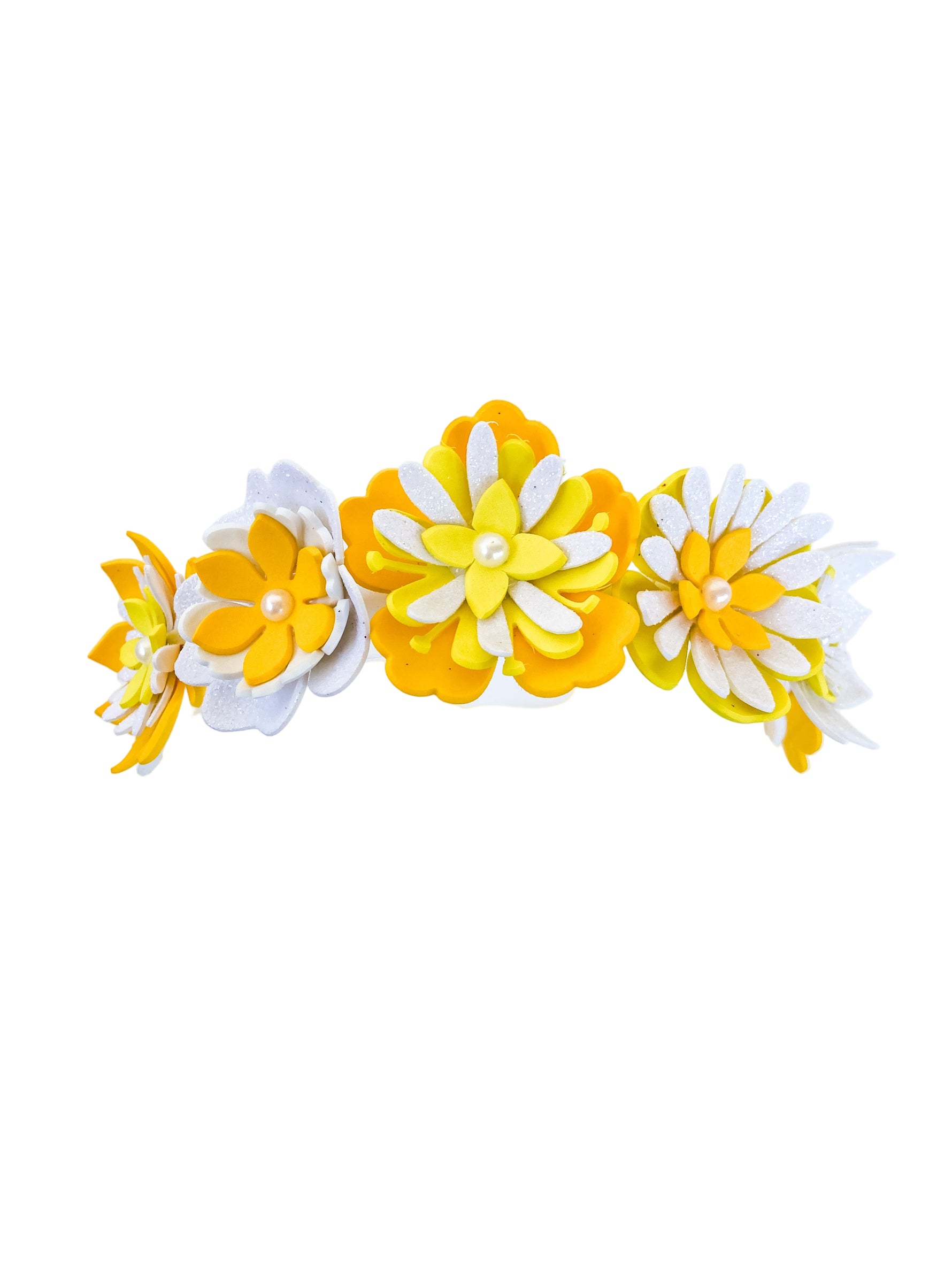 Decorative yellow and white floral hair clip on a white background
