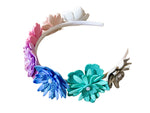 Colorful floral headband with antlers on a wooden surface