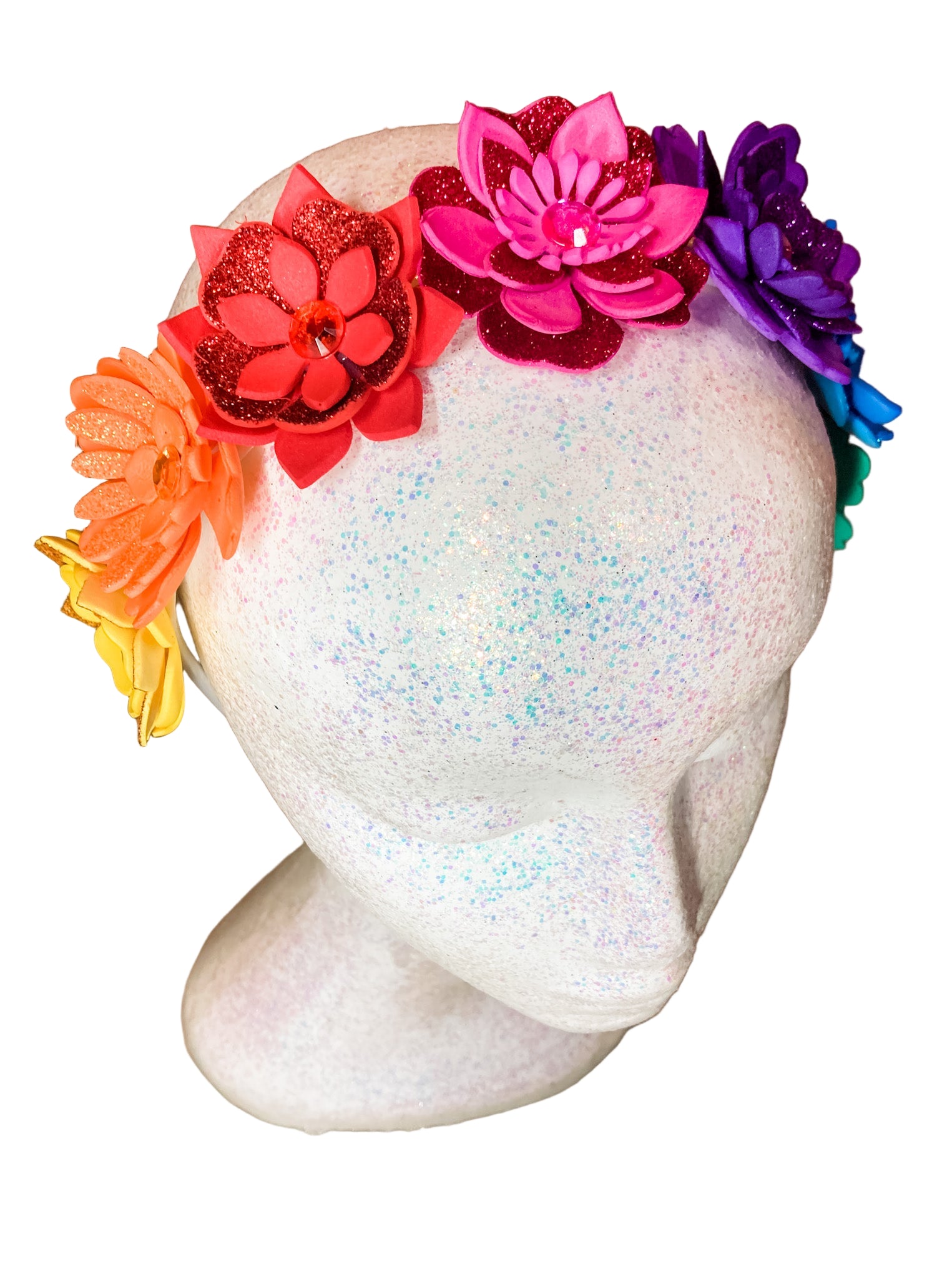 Colorful flower headband on a mannequin head with a wooden background