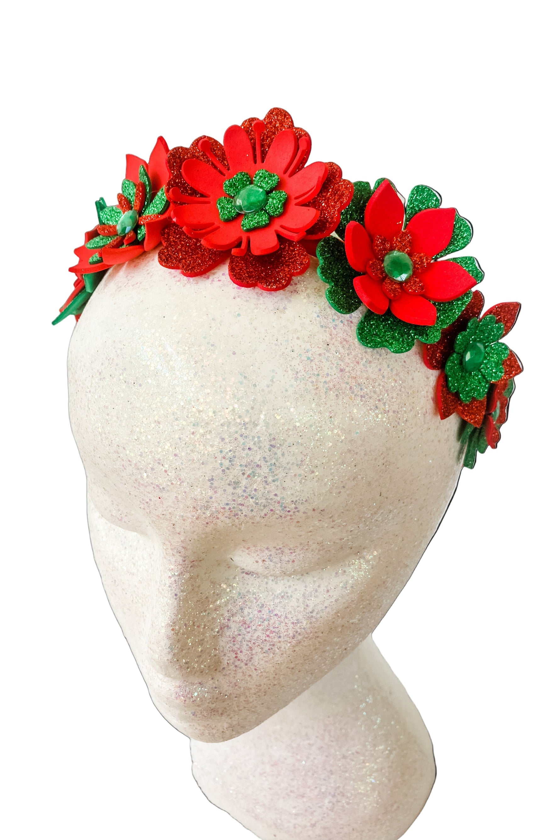 Red and green floral headband on a mannequin head against a white background