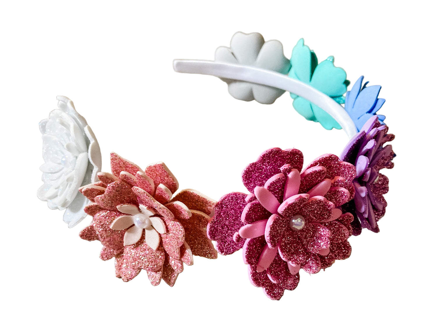Colorful flower headbands on a wooden surface