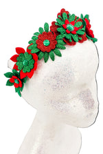 Red and green floral headband on a mannequin head against a white background