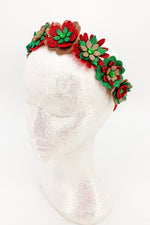Decorative red, gold and green floral headband on a white background