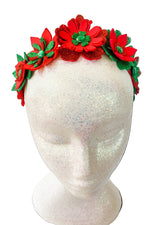 Red floral headband with green accents on a mannequin head against a white background