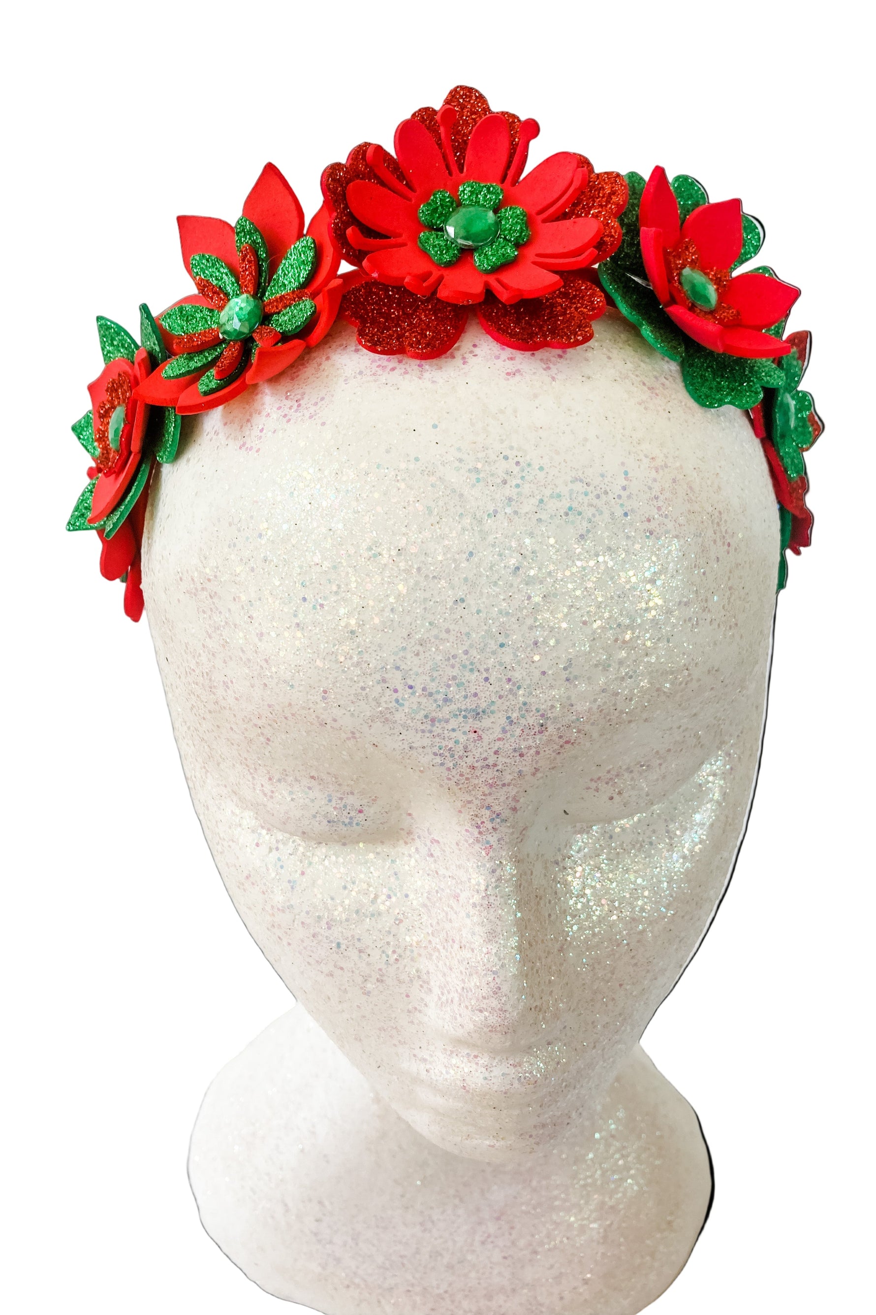 Red floral headband with green accents on a mannequin head against a white background