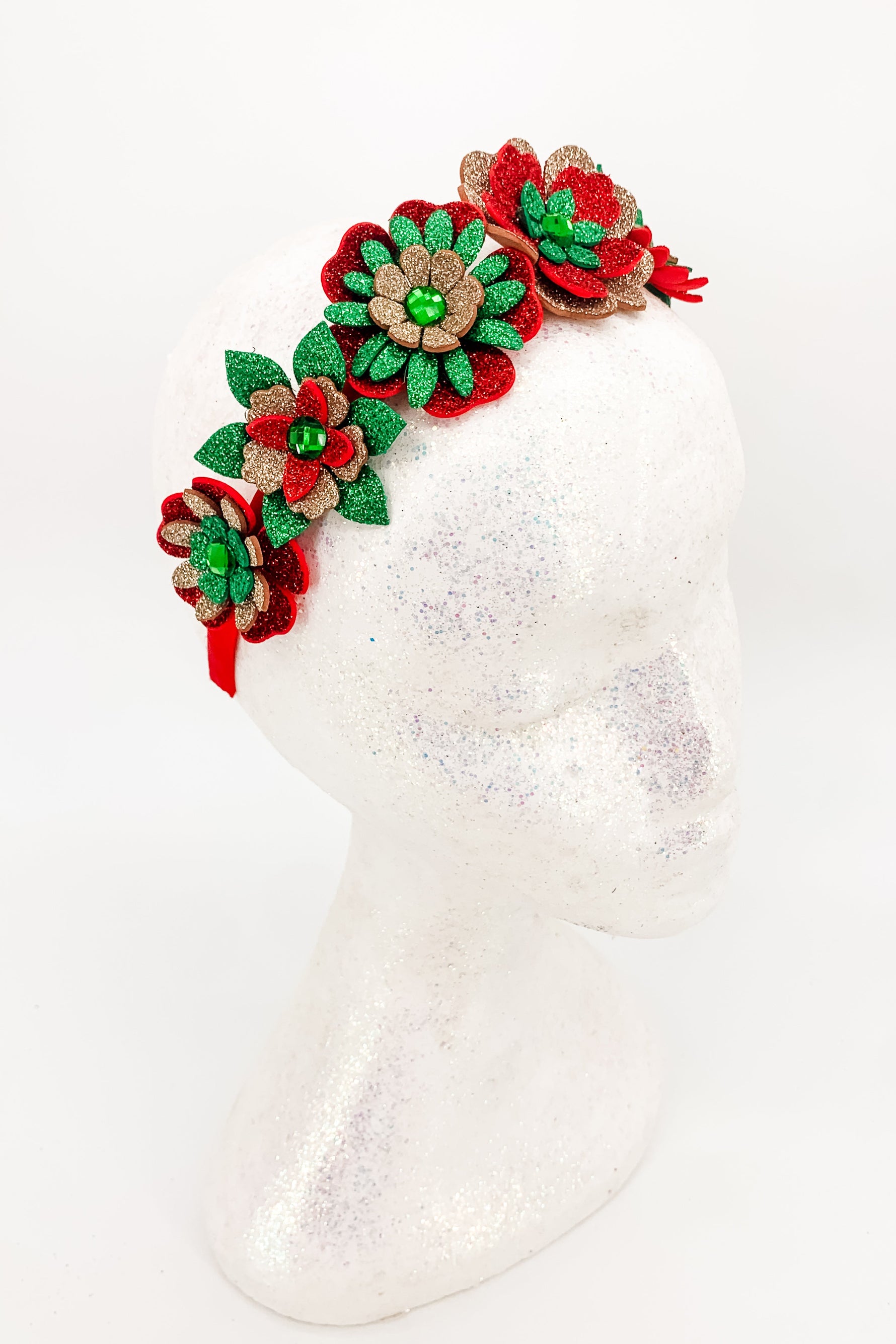 Decorative headband with red, green, and brown flowers on a white background